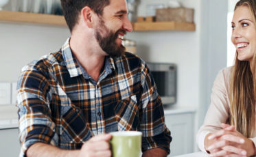 Couple laughing in a kitchen