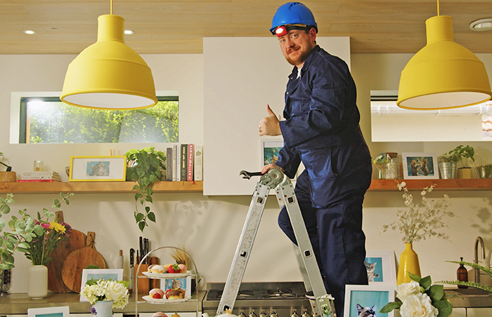 Builder giving a thumbs up on a ladder