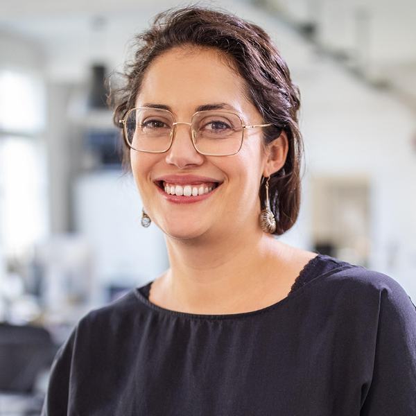 Woman smiling with her arms crossed.