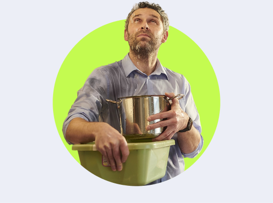 A man with a leak above him holding a basin and a pot.