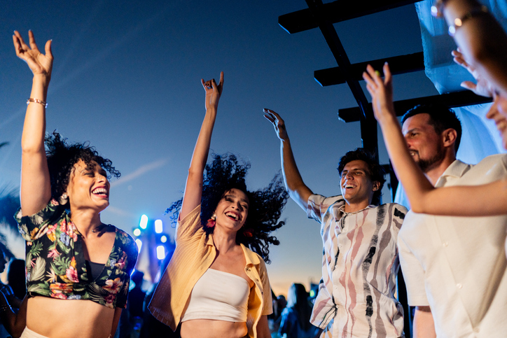 A group of people dancing at a festival.