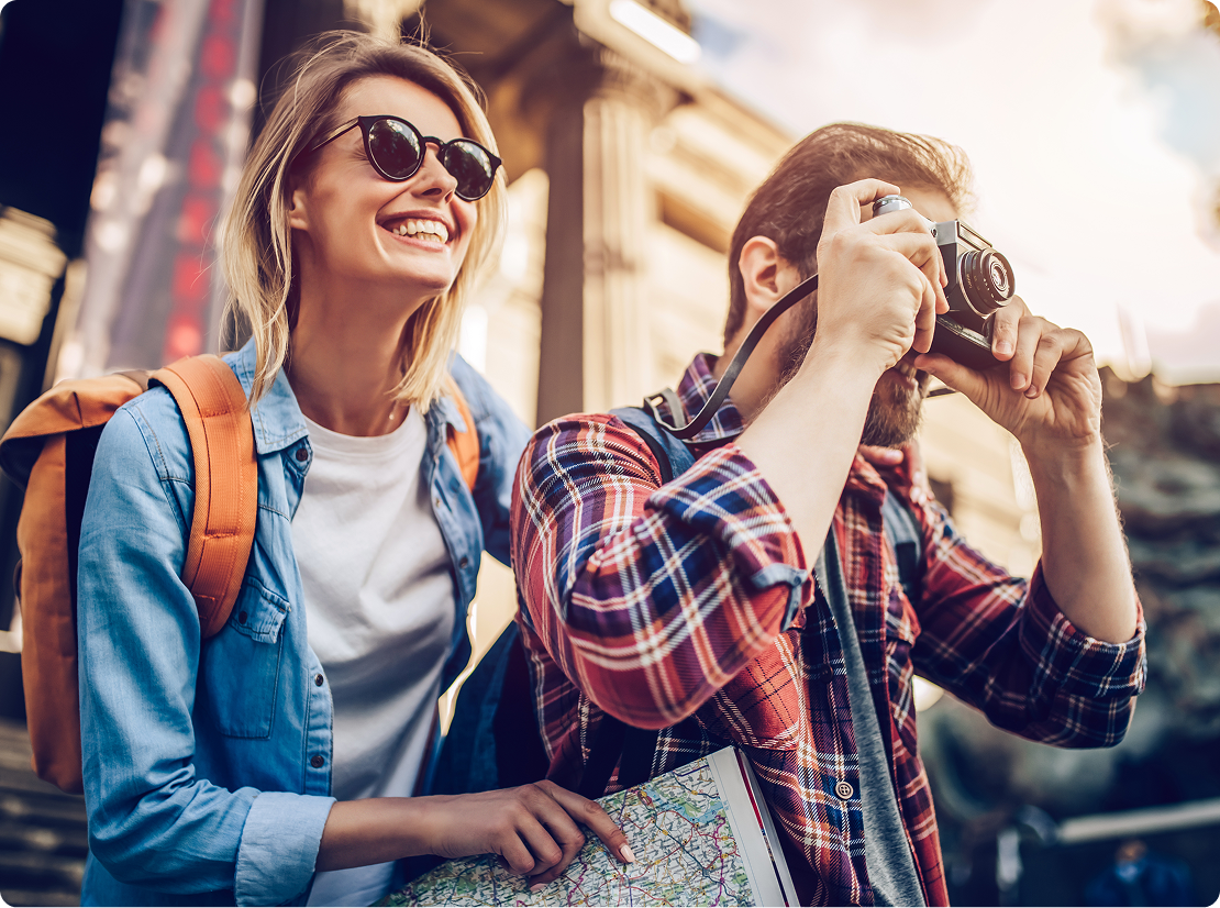 A couple smiling and taking photographs.