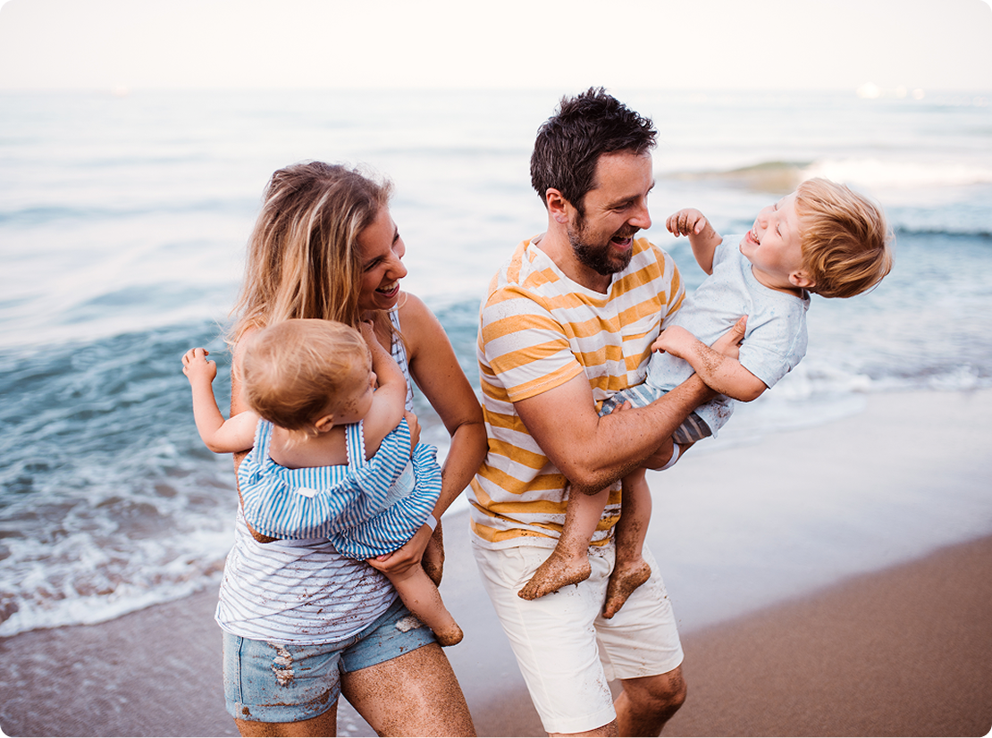 A family playing on the beach.